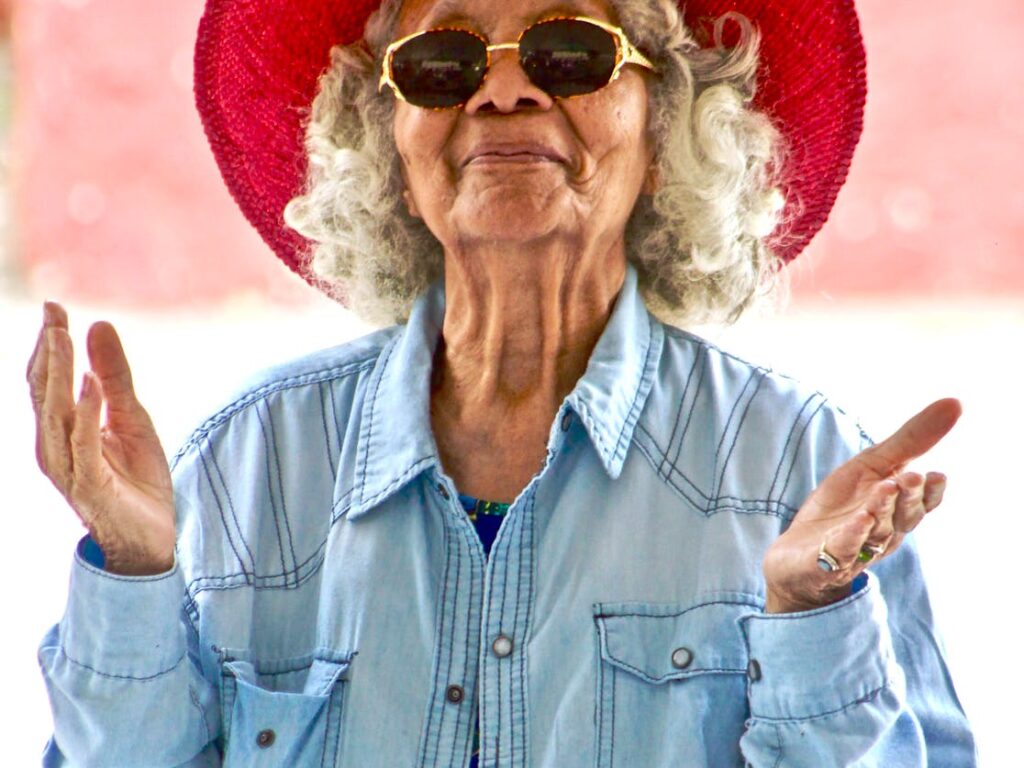 woman wearing red hat and sunglasses
